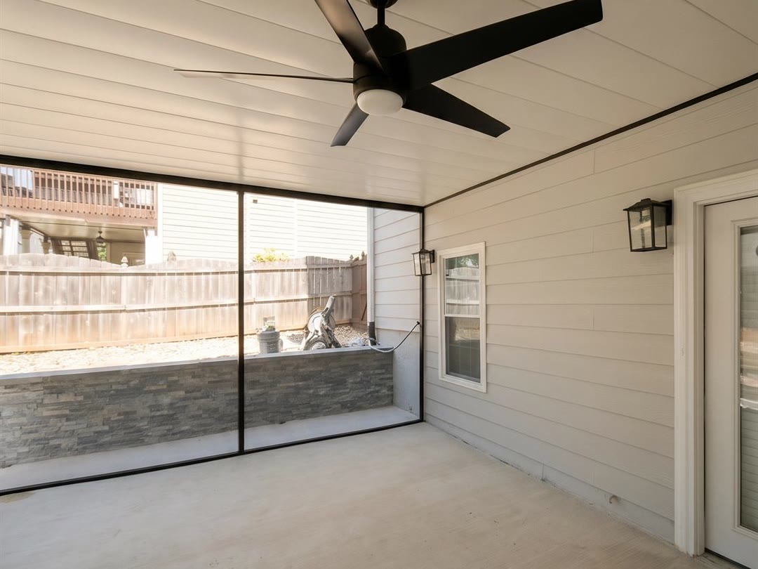 Dry outdoor living space beneath a second-storey deck