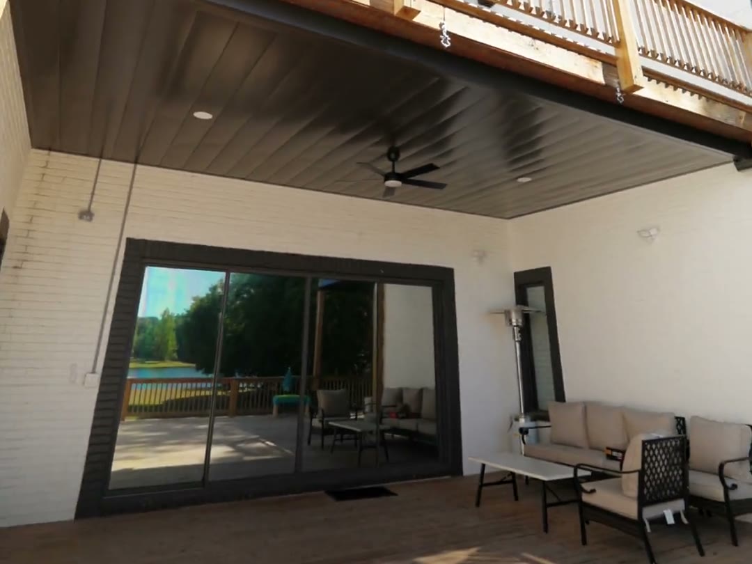 Fully furnished outdoor living room beneath a finished underdeck ceiling